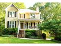 Beautiful home featuring a covered porch and well-maintained landscaping at 51 Vienna Way, Douglasville, GA 30134