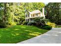 Charming two-story home with a lush green lawn and mature trees at 51 Vienna Way, Douglasville, GA 30134