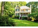 Charming home surrounded by mature trees and a well-kept lawn at 51 Vienna Way, Douglasville, GA 30134