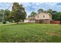 Well-maintained home featuring a spacious lawn, front porch, and an attached two-car garage at 618 Summerville Dr, Lawrenceville, GA 30046