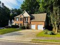 Lovely two-story home with a brick facade, black shutters, and an attached two car garage at 108 Northcutt Station Pl, Acworth, GA 30101