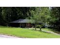 Charming single-story brick home with a well-manicured lawn and mature trees at 2493 Springdale Rd, Atlanta, GA 30315