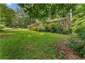 Beautifully landscaped front yard with a view of the charming brick house at 2493 Springdale Rd, Atlanta, GA 30315