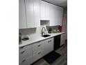 Modern kitchen featuring white cabinets, quartz countertops, stainless steel sink and hardwood floors at 2493 Springdale Rd, Atlanta, GA 30315