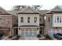 Charming brick townhome with a gray roof, black metal awnings, and a two-car garage at 512 Winston Croft Cir # 56, Johns Creek, GA 30022