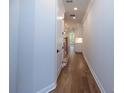 Hallway view with hardwood flooring and neutral colored walls at 512 Winston Croft Cir # 56, Johns Creek, GA 30022