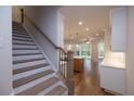 Staircase view towards a spacious living room and kitchen at 512 Winston Croft Cir # 56, Johns Creek, GA 30022