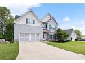 Traditional two-story home featuring a two-car garage, well-kept lawn, and neutral color scheme at 1016 Buckeye Ln, Villa Rica, GA 30180
