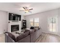 Inviting living room with fireplace, TV, ceiling fan, and access to the outside at 11730 Chatham Dr, Hampton, GA 30228