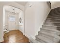 Welcoming entryway with beautiful hardwood flooring and a staircase leading upstairs at 2396 Whiteoak Se Bnd # 16, Smyrna, GA 30080