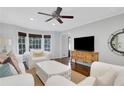 Comfortable living room featuring large windows, hardwood floors, and stylish furnishings at 435 Grenock Cir, Atlanta, GA 30328