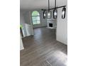 Open concept living room with fireplace, large window and modern lighting at 5709 Newnan Cir, Austell, GA 30106