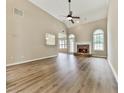 Open living room with vaulted ceilings, a stone fireplace, and large windows offering plenty of natural light at 114 Saddle Wood Dr, Dallas, GA 30157