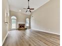 Spacious living room with vaulted ceiling, a fireplace, hardwood floors and large windows at 114 Saddle Wood Dr, Dallas, GA 30157