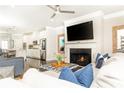 Cozy living room with fireplace, tv, ceiling fan, and view of the eat-in kitchen at 3133 Quinn Pl, Atlanta, GA 30341