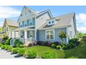 Charming two-story home featuring a welcoming front porch and lush landscaping at 9990 Blackfriars Rd, Douglasville, GA 30135