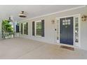 Inviting front porch with a ceiling fan, fresh paint, dark shutters and space to relax at 1180 Branch Water Ct, Dunwoody, GA 30338