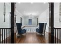 Elegant living room featuring hardwood floors, stylish furniture, and custom wall paneling at 1180 Branch Water Ct, Dunwoody, GA 30338