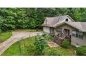 This home boasts an attached garage, a driveway, and lots of surrounding green space at 2026 Mcdaniel Mill Sw Rd, Conyers, GA 30094