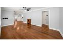 Spacious living room with hardwood floors, ceiling fan, and a cozy electric fireplace at 2100 Shady Ln, Tucker, GA 30084