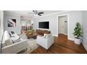 Bright living room with a ceiling fan, with elegant furniture, stylish rug and decor at 2100 Shady Ln, Tucker, GA 30084