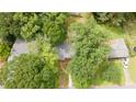 Birds eye view of a gray home with a driveway, lush trees, and surrounding greenery at 4339 Sasanqua Ct, Tucker, GA 30084