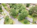An aerial view showing the gray home surrounded by mature trees in a quiet neighborhood at 4339 Sasanqua Ct, Tucker, GA 30084