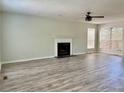 Bright living room featuring fireplace, ceiling fan, and lots of natural light at 5105 N Bridges Dr, Alpharetta, GA 30022