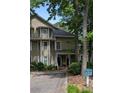 View of a well-maintained condo with a covered porch and verdant landscaping at 1416 Oakridge Cir, Decatur, GA 30033