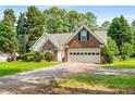 Beautiful home with brick and siding, a well-manicured lawn, green door, and two-car garage at 1978 Elmwood Cir, Snellville, GA 30078
