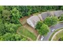 This aerial shot captures a home with a private, fenced backyard bordered by lush trees at 1029 Harvest Brook Dr, Lawrenceville, GA 30043