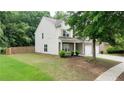 Lovely home showcasing a well-kept lawn, a two-car garage, and a welcoming front porch at 1029 Harvest Brook Dr, Lawrenceville, GA 30043