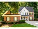 Charming brick home with black shutters and manicured landscaping for great curb appeal at 1304 Carrington Way, Lawrenceville, GA 30044