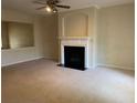 Spacious living area with a decorative fireplace, carpet flooring and neutral walls at 2858 Parkway Close, Lithonia, GA 30058