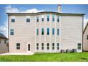 The home's backyard features several windows, a grassy lawn, and a patio at 3740 Lake Enclave Way, Atlanta, GA 30349