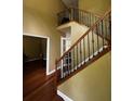 Staircase with wood railing and wrought iron spindles at 3796 Melvin Sw Dr, Atlanta, GA 30331
