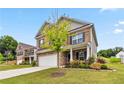 Beautiful two-story brick home featuring a lush green lawn and neatly landscaped flowerbeds at 6094 Whitetail Deer Run, Mableton, GA 30126