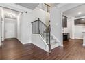 Inviting foyer with hardwood floors, staircase, and a view of the kitchen at 6094 Whitetail Deer Run, Mableton, GA 30126
