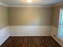 The dining room features sleek flooring, wainscotting details, and a large window at 1093 Hasty Sw Ct, Lilburn, GA 30047
