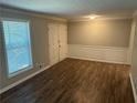 The living room has sleek flooring, a large window, and ample closet space at 1093 Hasty Sw Ct, Lilburn, GA 30047