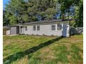 Charming single-story home with a modern gray brick facade, complemented by lush greenery at 1770 Atherton Dr, Decatur, GA 30035
