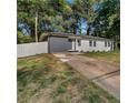 Charming single-story home with gray painted brick, complemented by a well-maintained driveway at 1770 Atherton Dr, Decatur, GA 30035