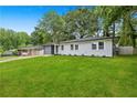 Lovely front yard view of this single-story home that has a freshly painted brick exterior at 1770 Atherton Dr, Decatur, GA 30035