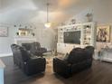 Cozy living room with a fireplace, media center, and comfortable furnishings at 2303 Condor Dr, Lawrenceville, GA 30044