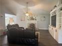Inviting living room featuring a fireplace, built-in shelving, and ample seating at 2303 Condor Dr, Lawrenceville, GA 30044
