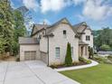 Side view of home featuring brick exterior, attached garage, and lush landscaping at 3459 Clubland Dr, Marietta, GA 30068
