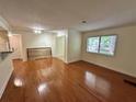 Bright living room featuring hardwood floors and large window, creating an inviting atmosphere at 1503 Wingate Way # 1503, Sandy Springs, GA 30350