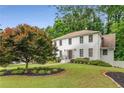 Charming two-story home with a brick facade, mature trees, and a lush green lawn at 1560 Boxwood Nw Trce, Acworth, GA 30102