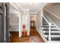Warm and welcoming foyer with hardwood floors, staircase, and decorative accents at 1560 Boxwood Nw Trce, Acworth, GA 30102