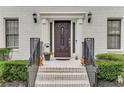 Inviting front entry with brick steps, a dark wood door and decorative details at 1560 Boxwood Nw Trce, Acworth, GA 30102